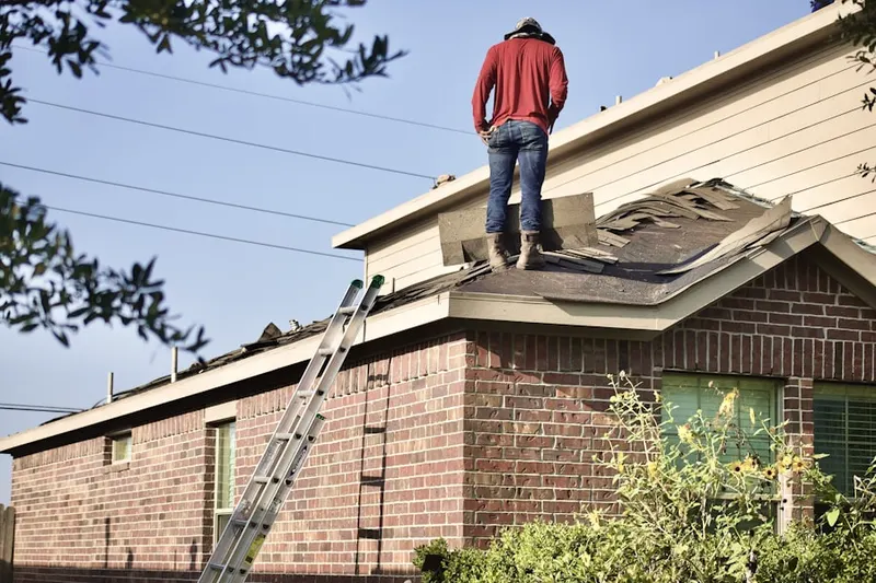 Professional roofer working on a residential roof in Naval Anacost Annex